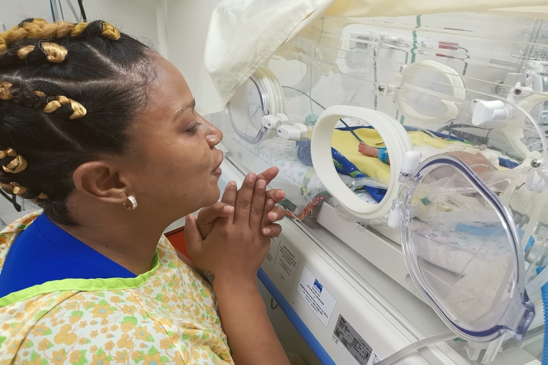 Mother singing to baby in the Dominican Republic