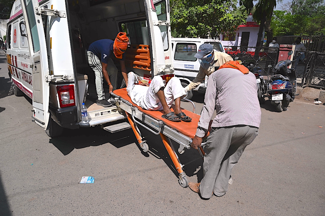 COVID-19 patient loaded into ambulance in India