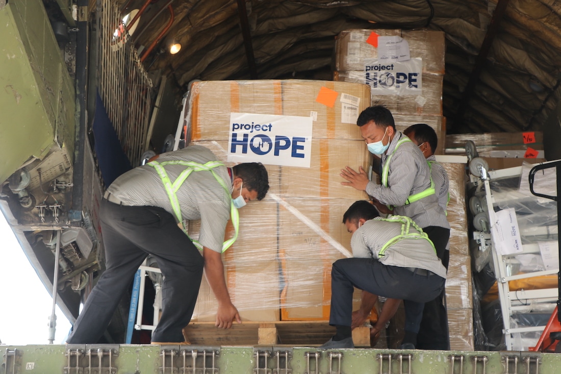 Workers unload Airlink shipment of PPE in Nepal