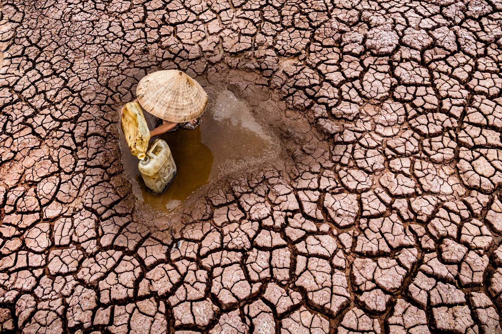 A young farmer savaging water in the midst of a severe drought. 