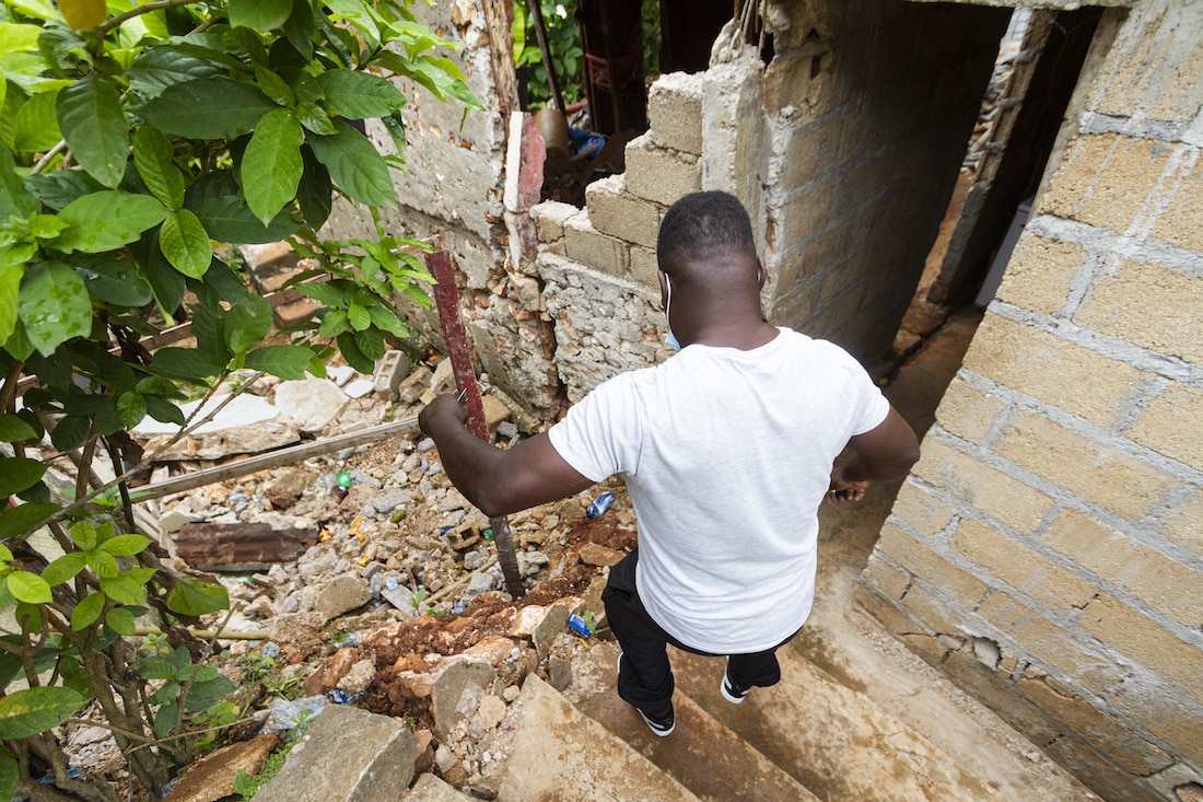 Jean Phito Dorestant surveying earthquake damage in Haiti