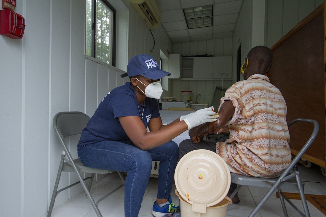 Nurse treating earthquake survivor in Haiti