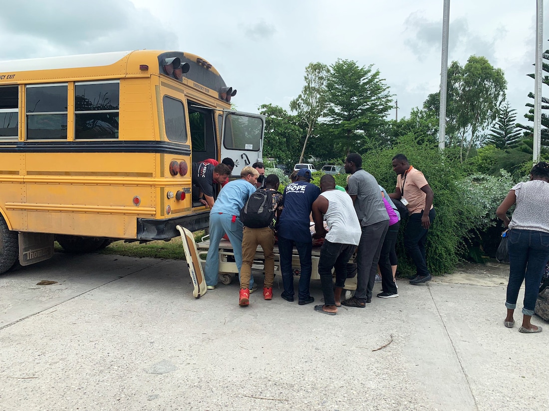 Patient loaded onto school bus in Haiti