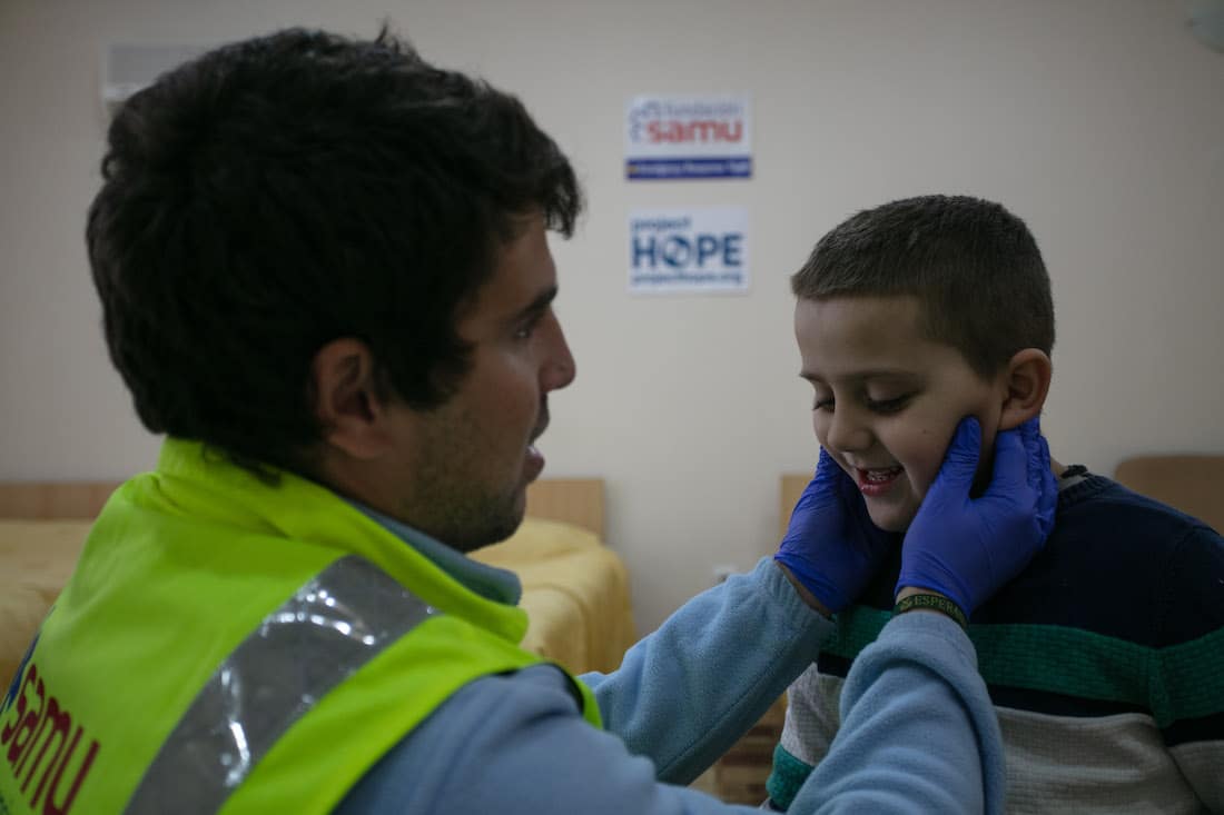 child being checked by doctor