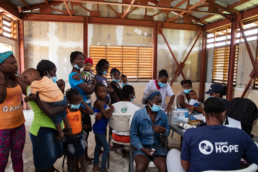 Patients receiving care at a Project HOPE mobile clinic in Boucan