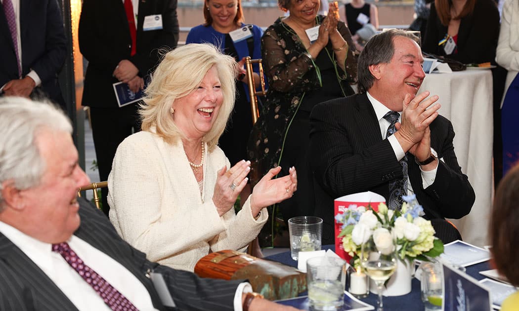 guests at event laughing and clapping