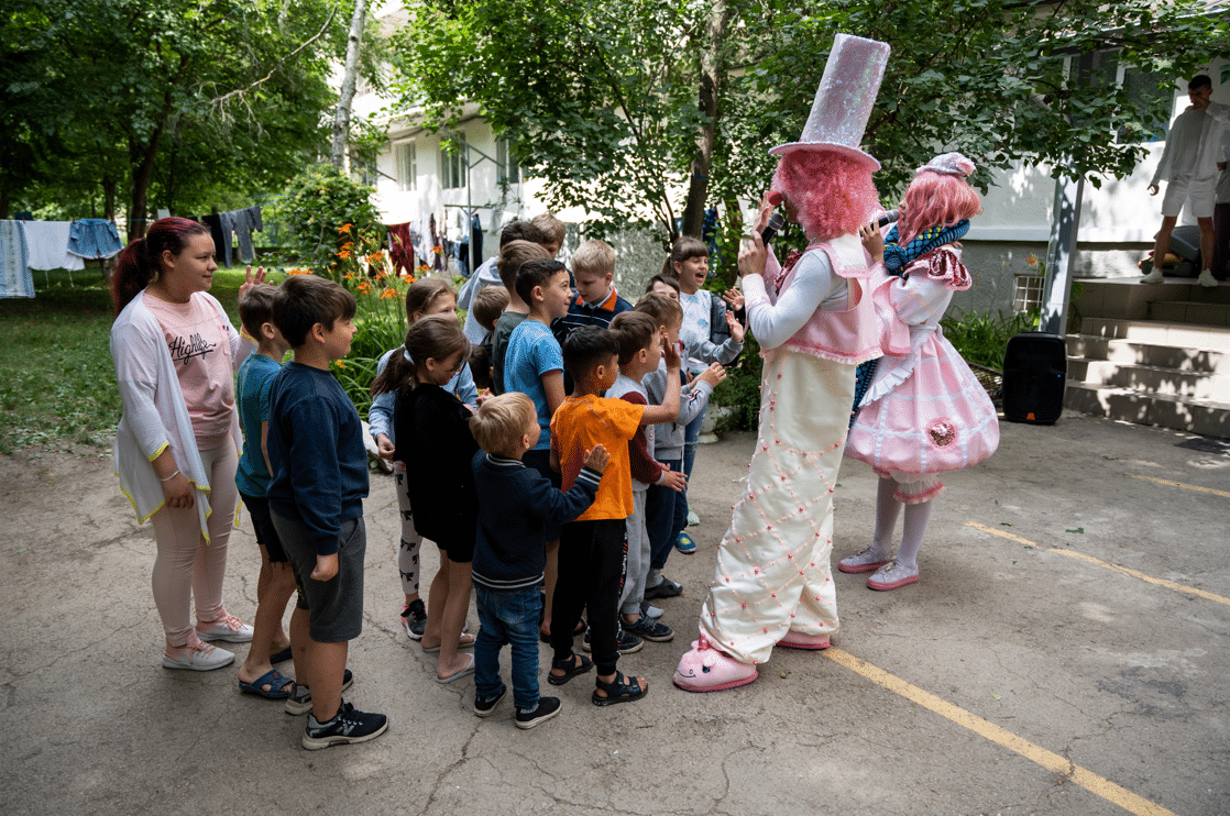 a clown playing with children