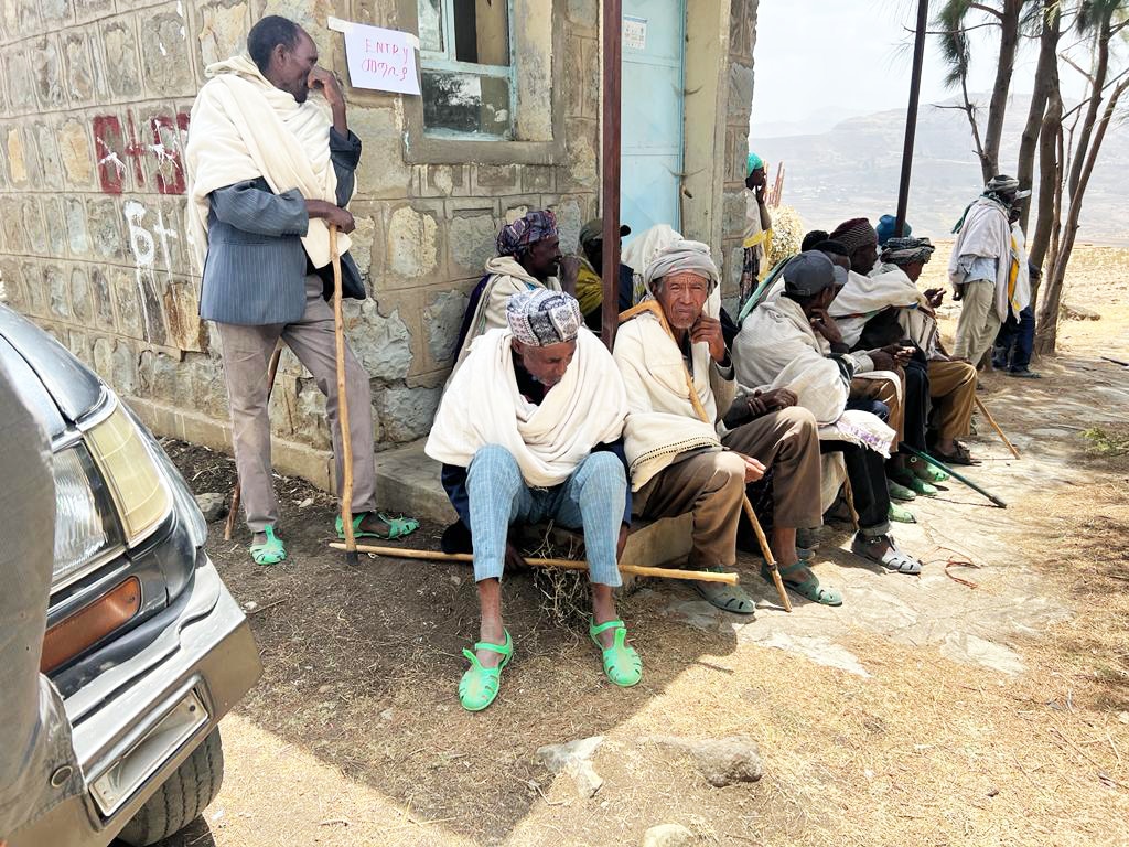 men sitting outside a medical building in Ethiopia