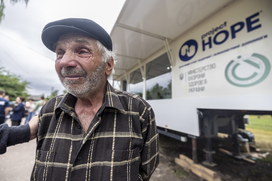 Man standing outside Project HOPE mobile clinic
