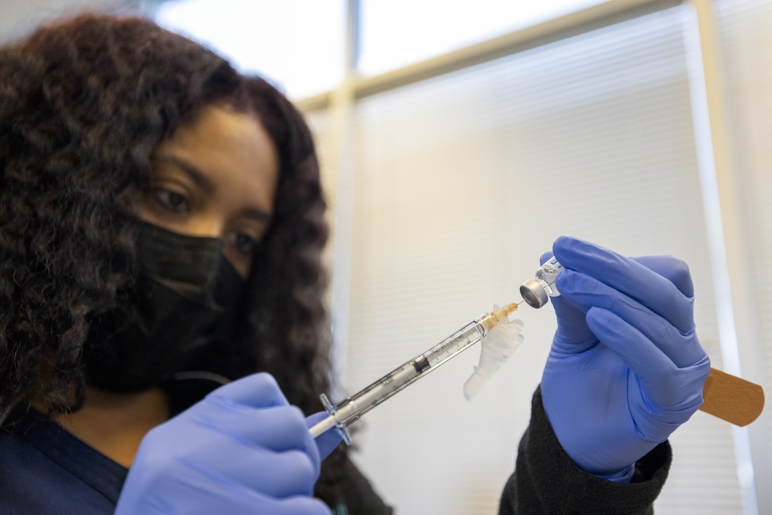 Health worker preparing COVID-19 vaccine