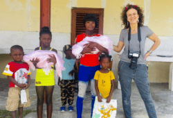 photographer standing with a family in Haiti