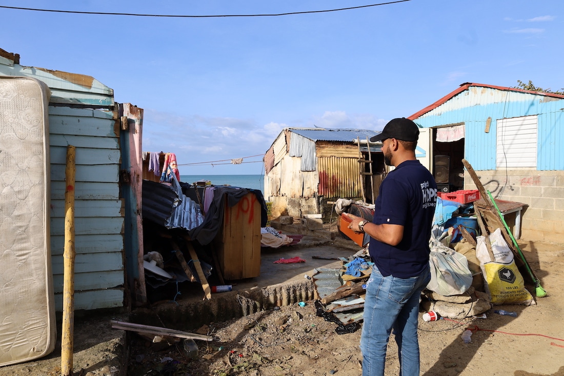 man surveying hurricane damage in the Dominican Republic