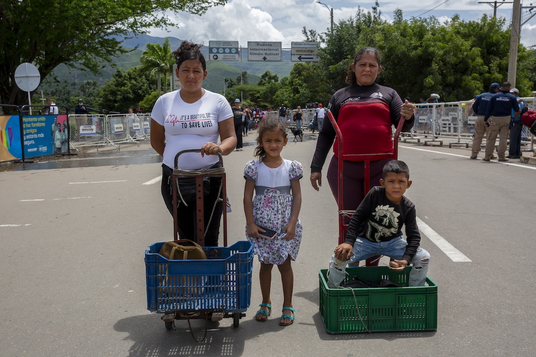 a family standing at the Venezuela and Colombia border