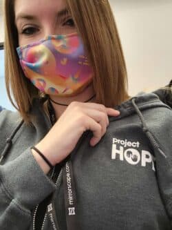 Atheena wearing a mask and project hope sweatshirt