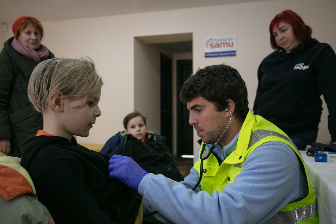 a doctor checks the health of a child in Moldova