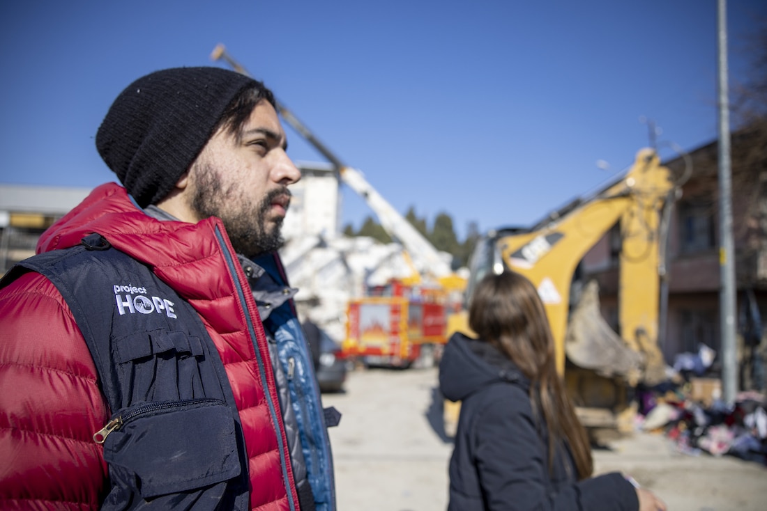 profile image of Armand Viscarri wearing Project HOPE gear and looking at the destruction in Turkey.