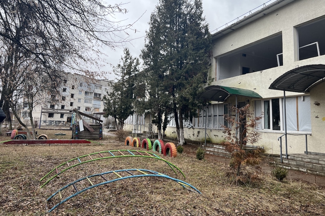 wide shot of schoolyard in Ukraine with various children's playground equipment.
