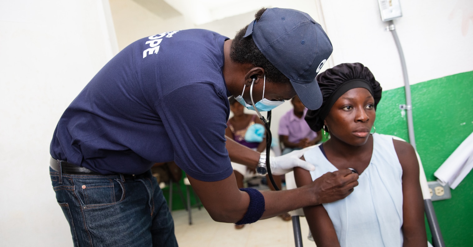 a doctor checking a woman in Haiti
