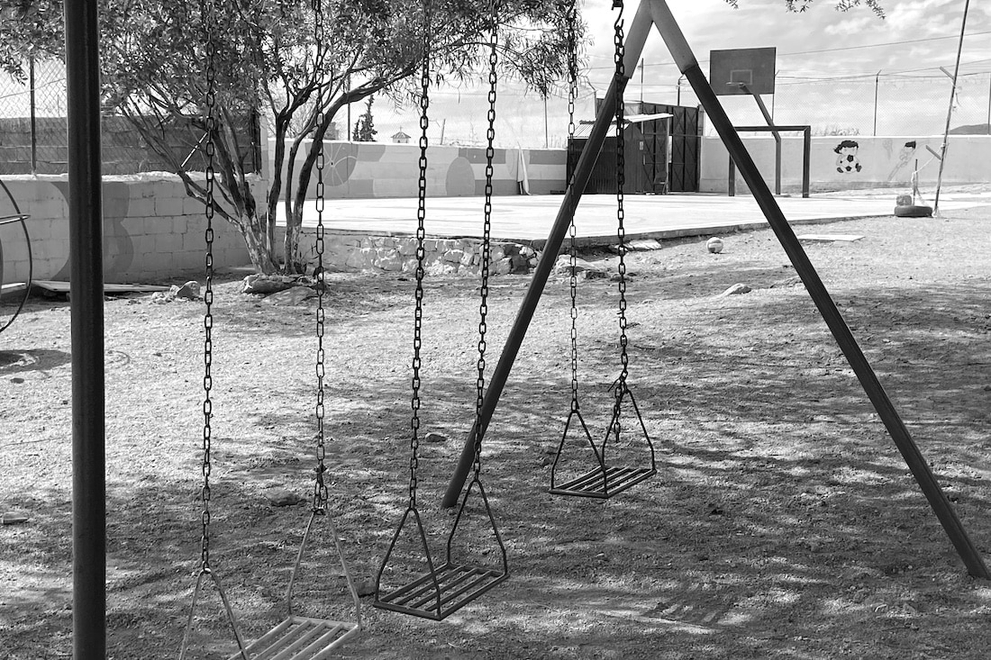 empty swingset at a migrant shelter in Mexico