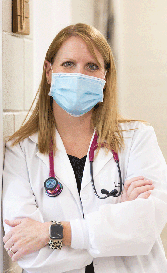 medical staff wearing a face mask poses for camera