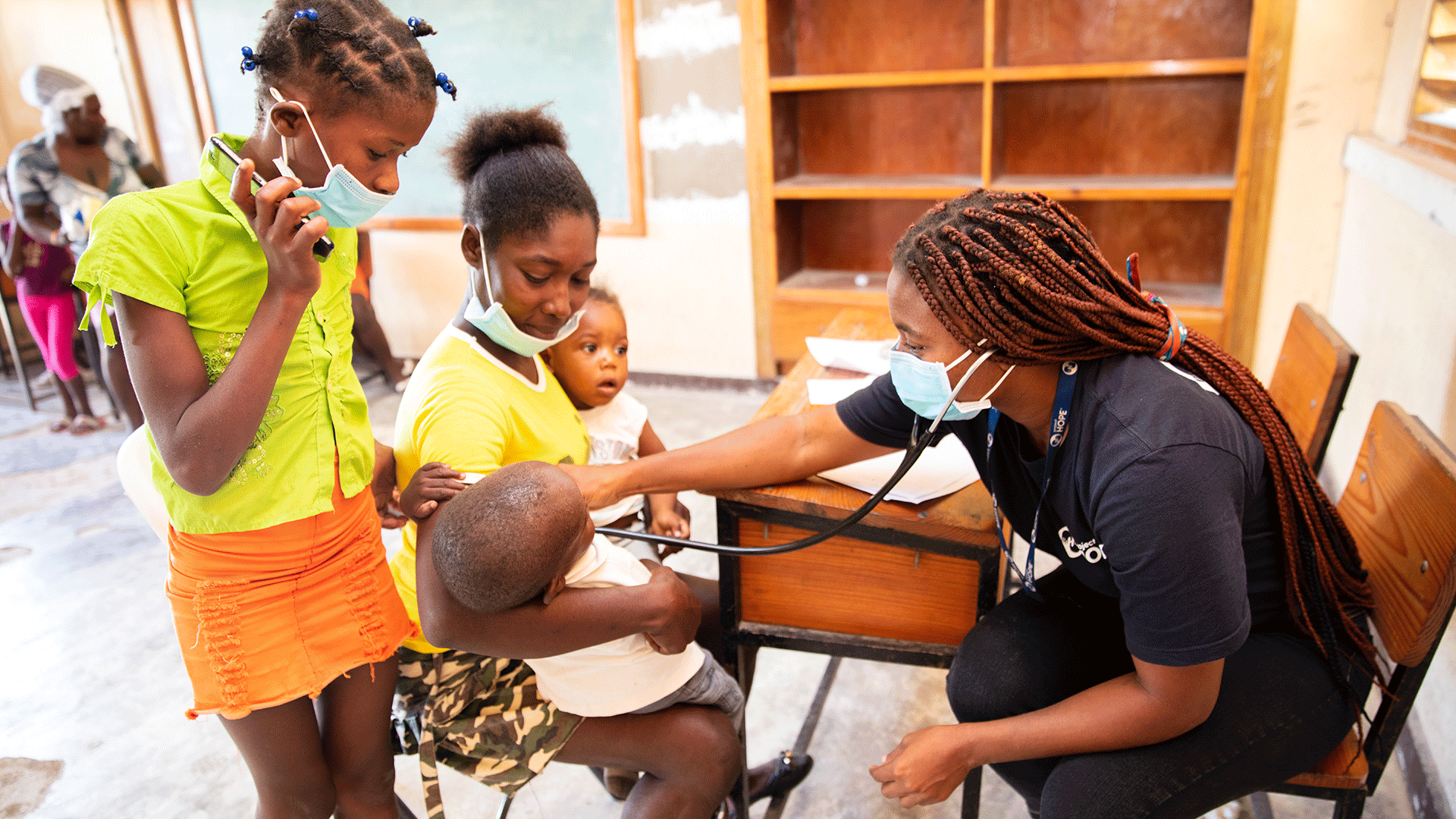 a nurse checks on a child in Haiti