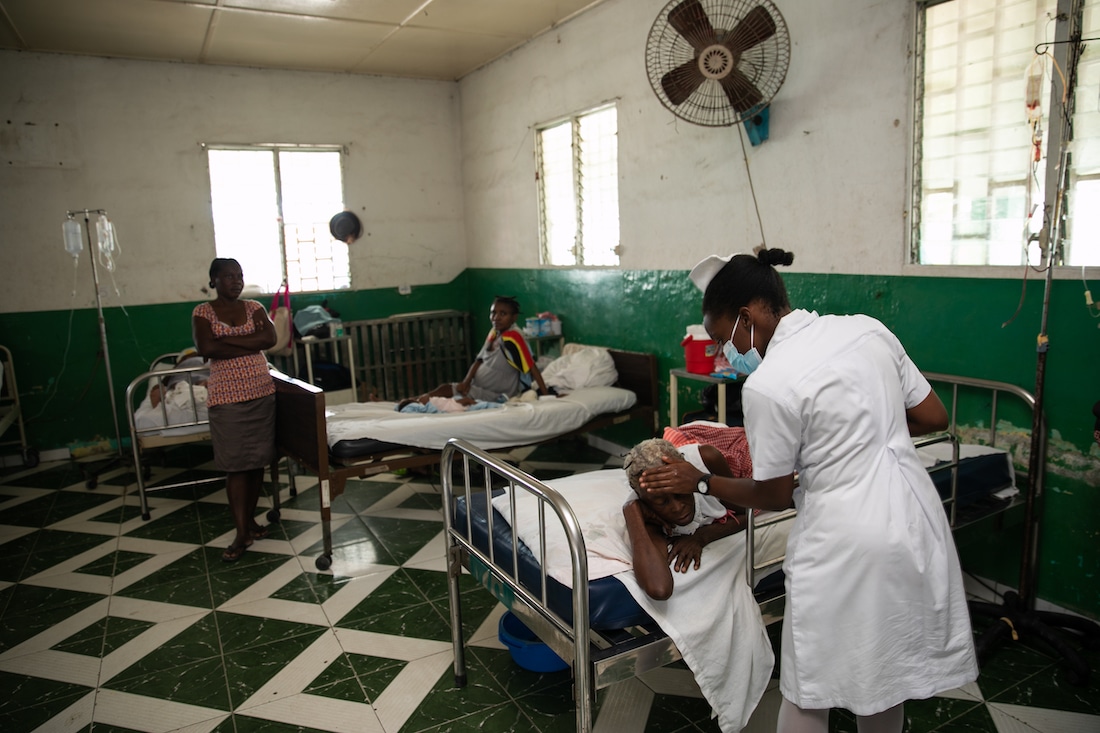 a nurse attending to a patient in a hospital in Haiti.