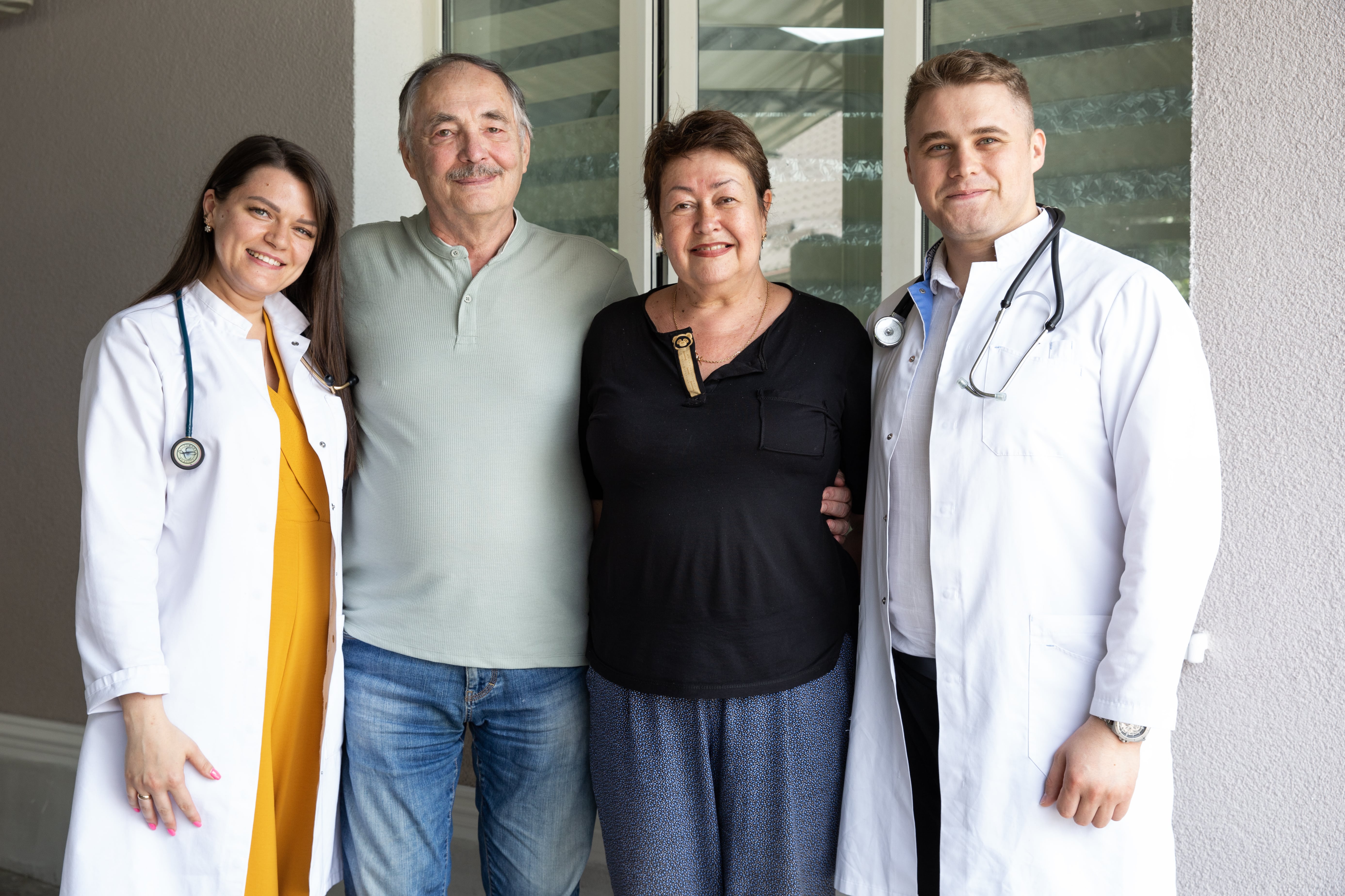 a group of doctors standing together with their patient