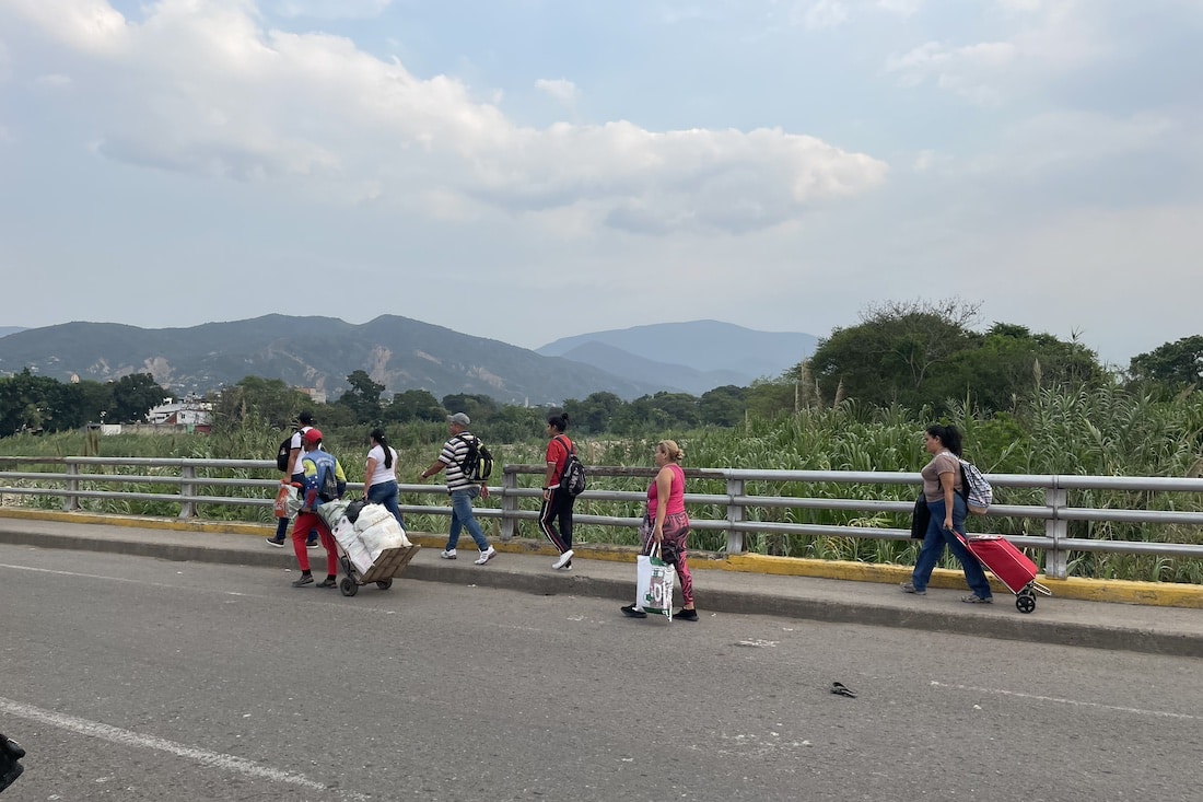 Venezuelans cross back over the border before it closes. 