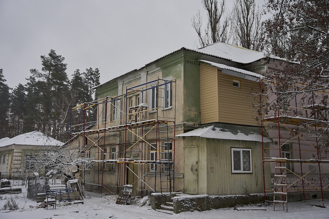 Progress shot of hospital being worked on in the wintertime with snow on the ground.