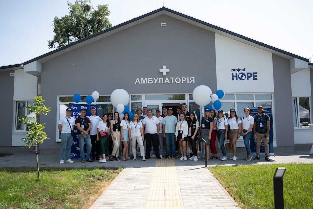 Group of people standing outside the new hospital in Ukraine.