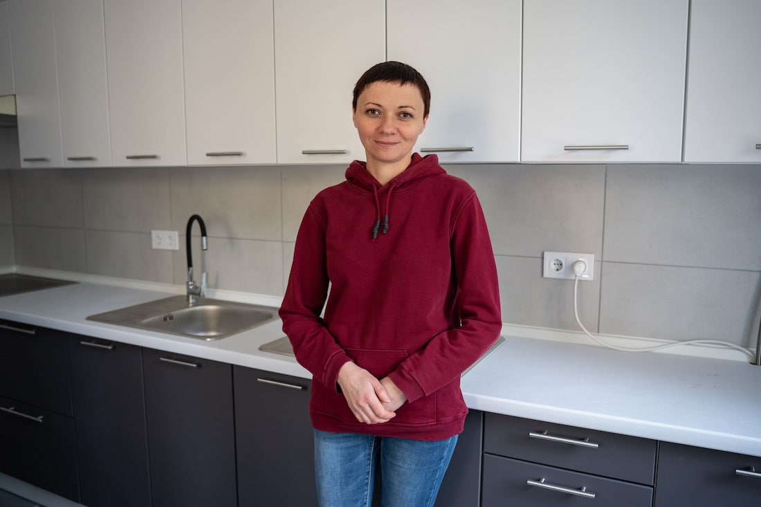 woman standing next to sink