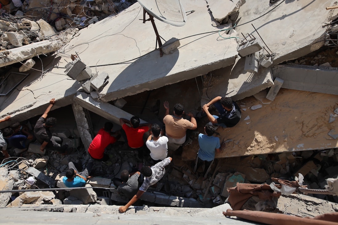 people going through rubble in Gaza