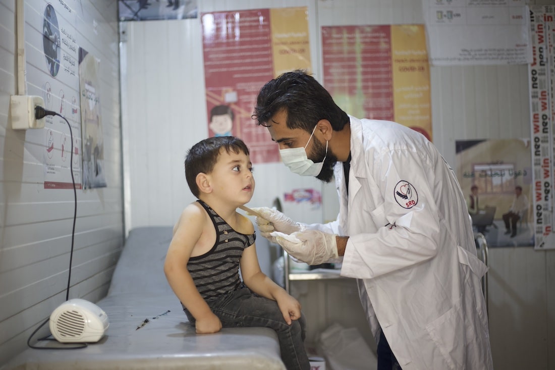 young boy being examined by a doctor
