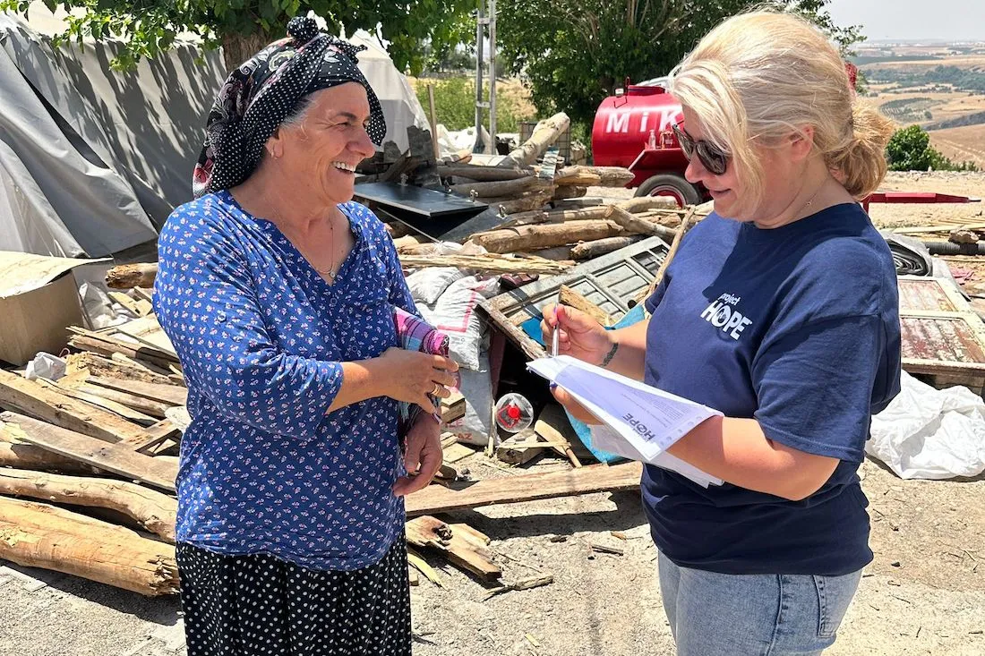 women talking in front of home