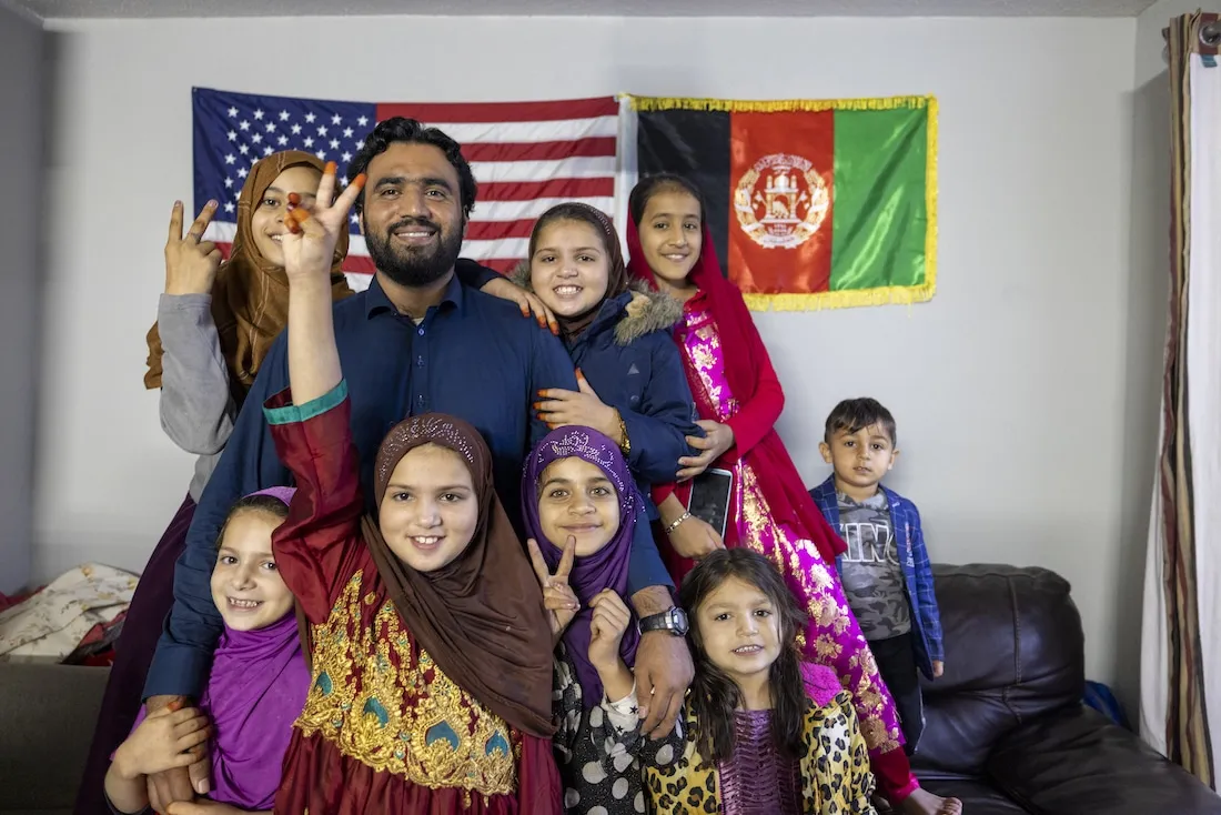 man with family of children smiling to camera