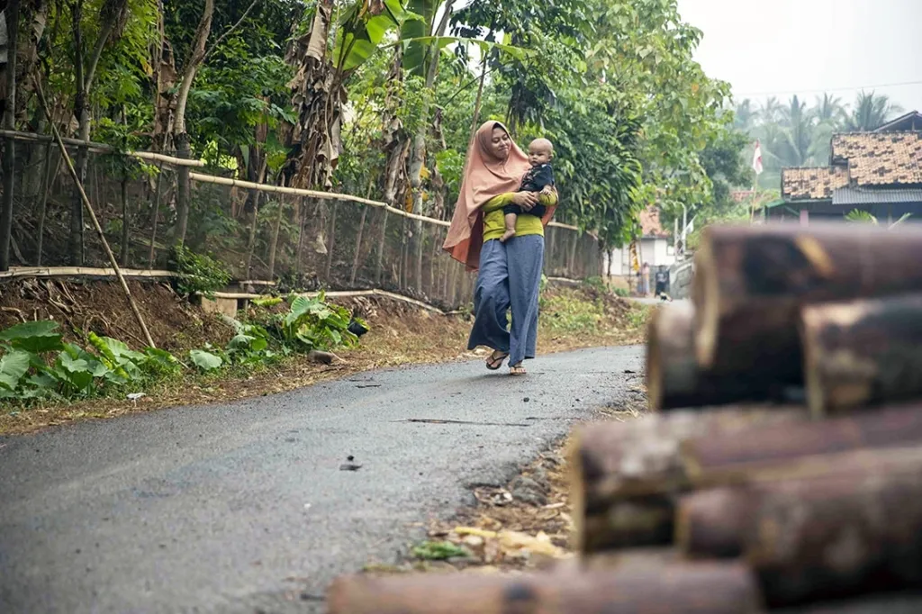 Mother carrying newborn child