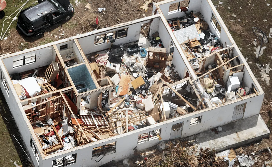 House with rubble and the roof torn off
