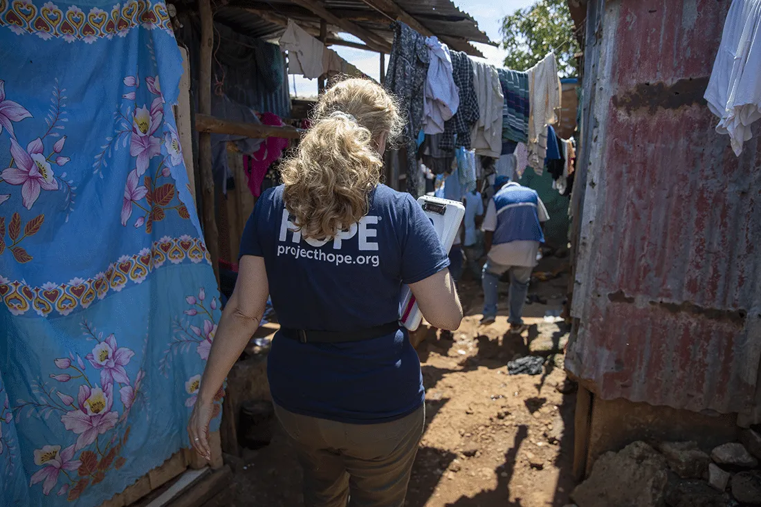 woman walking through village