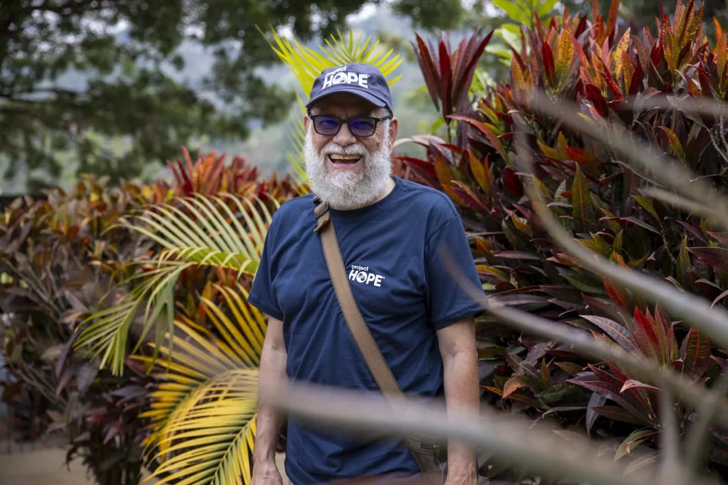 old man in Project HOPE gear smiling