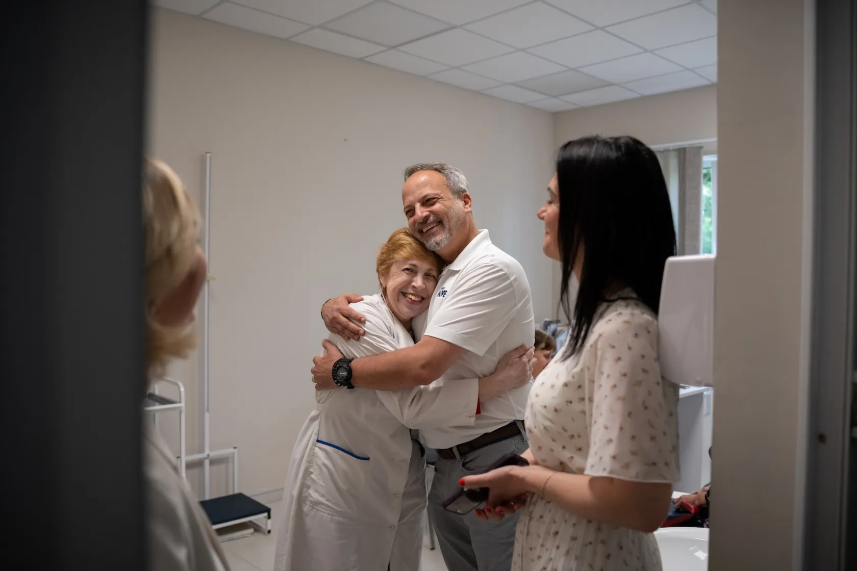 Man and woman hug together inside hospital