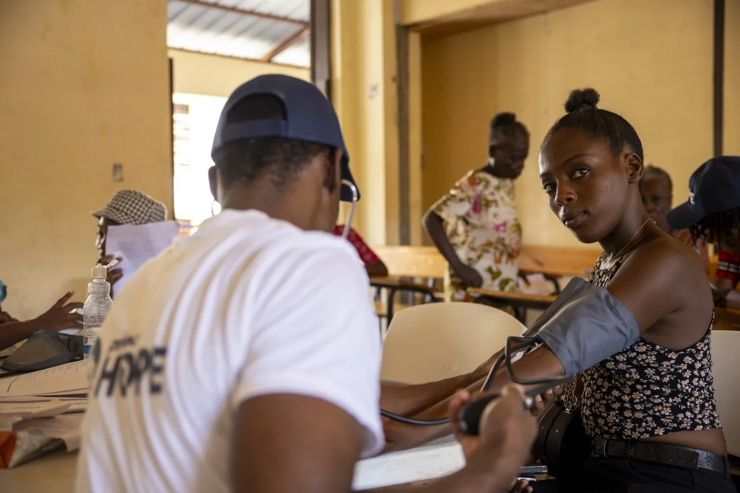 woman gets her blood pressure checked by medical staff in Haiti