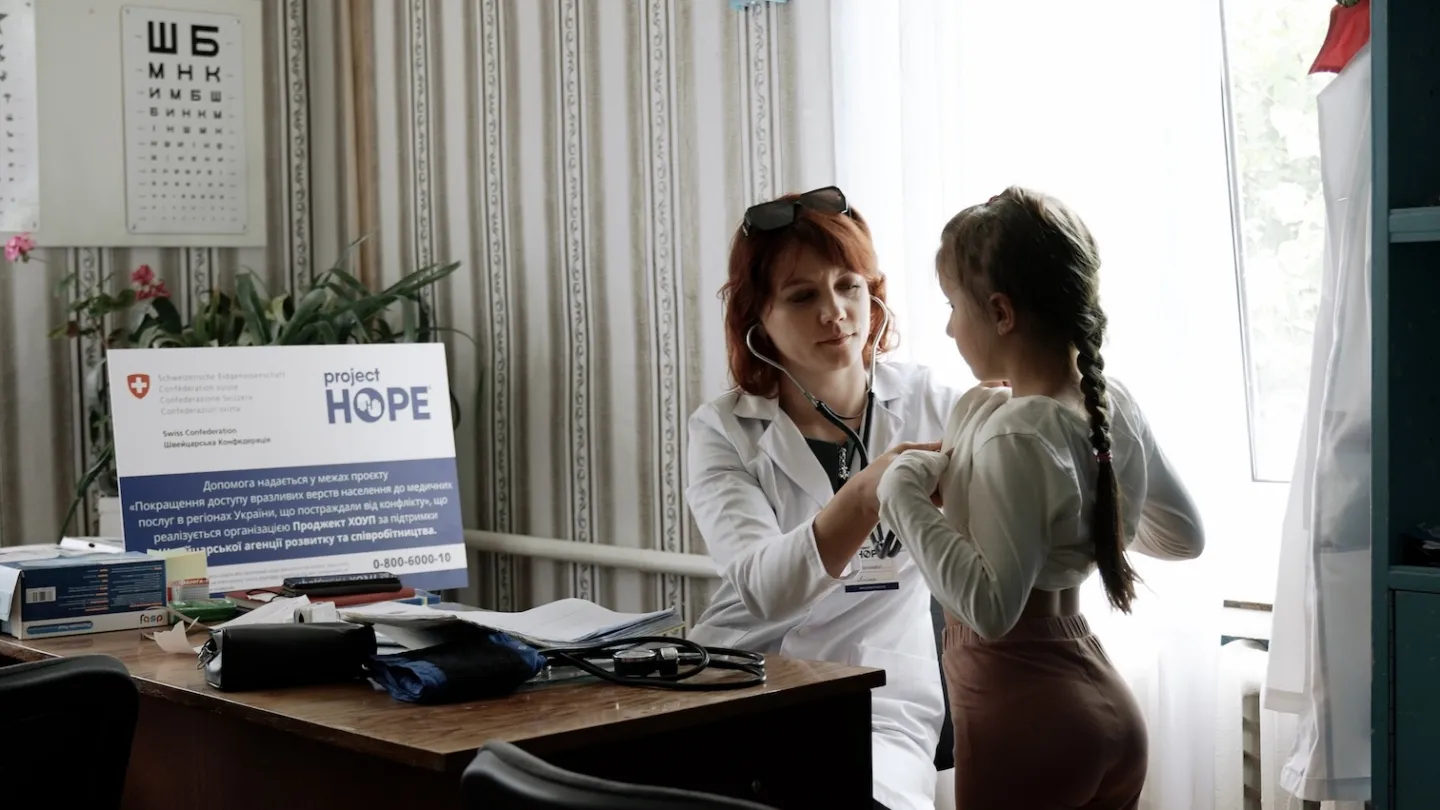 medical staff checking lungs of young girl