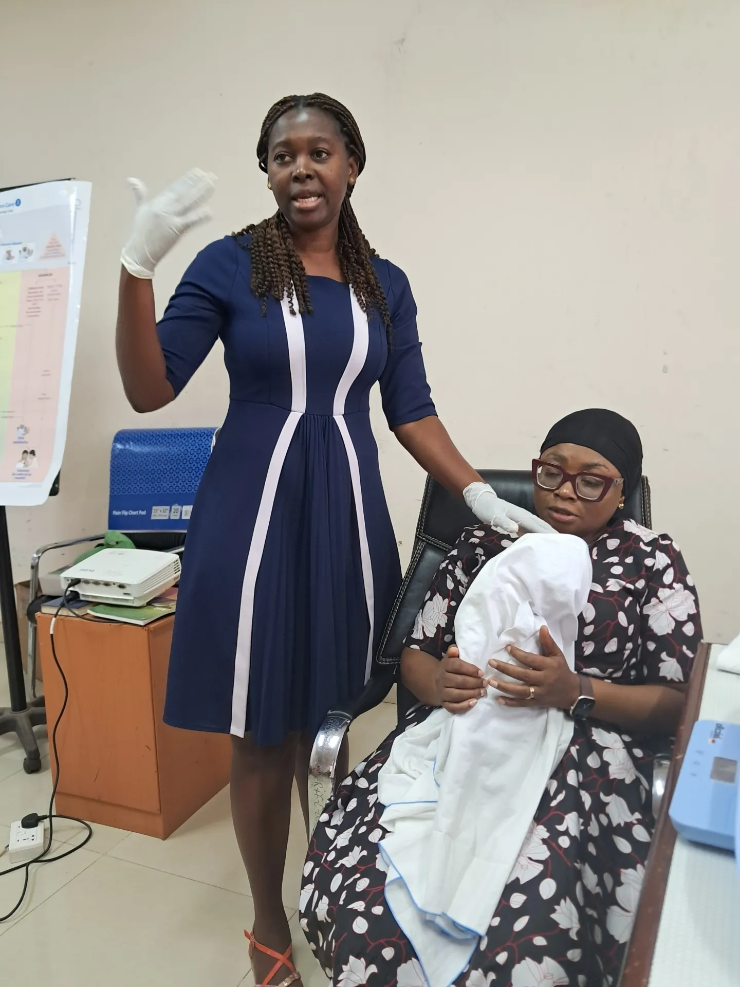 midwife cares for mother with newborn