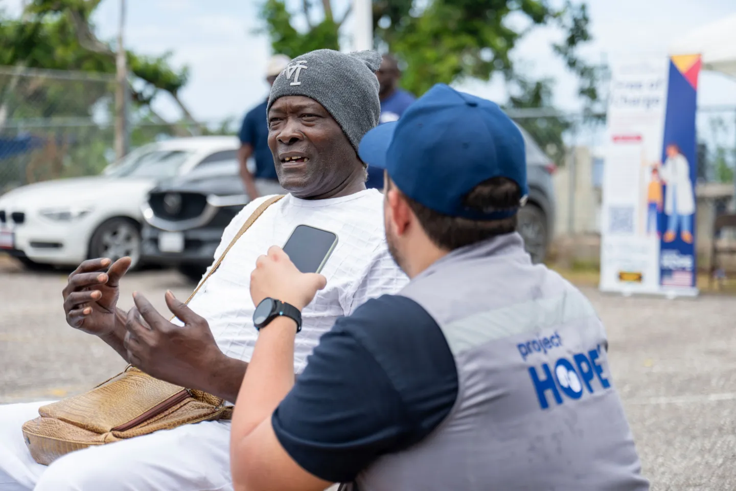 elderly man shares story with Project HOPE staff in Jamaica