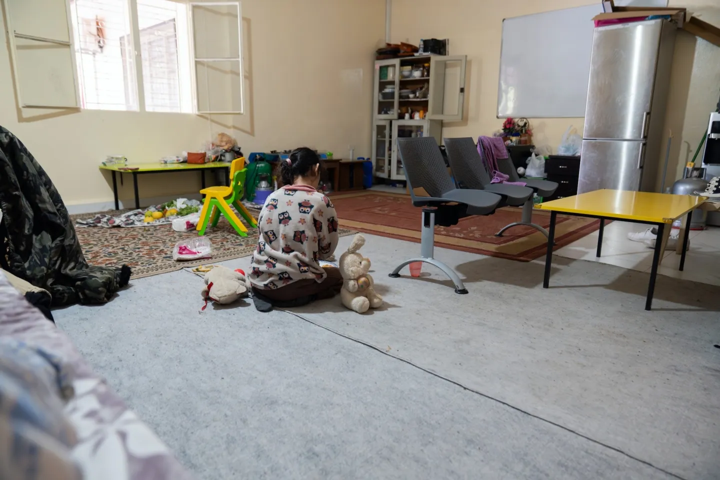 young girl plays with toys inside clinic in Lebanon