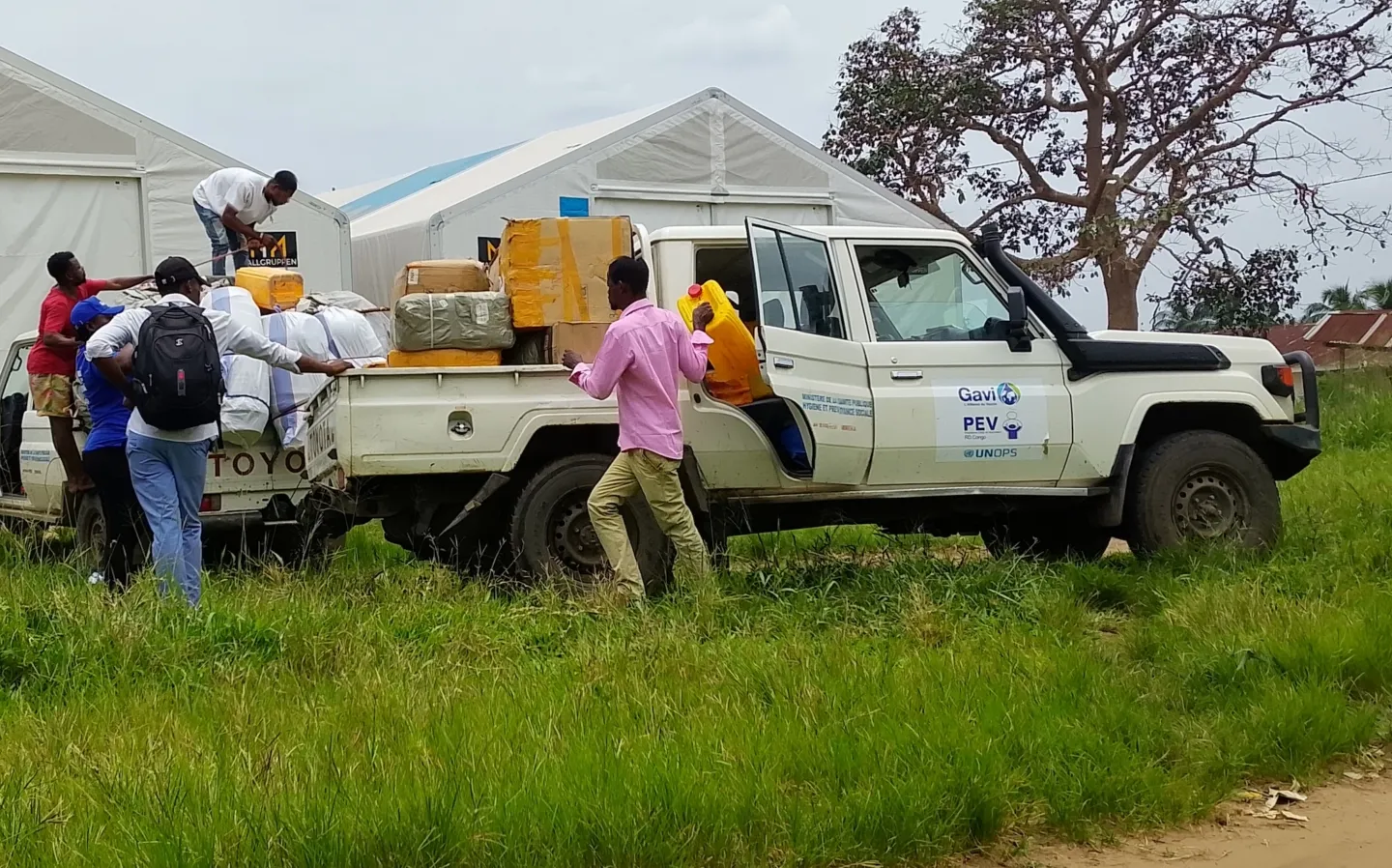 group of people taking supplies off of truck for Ebola response in DRC