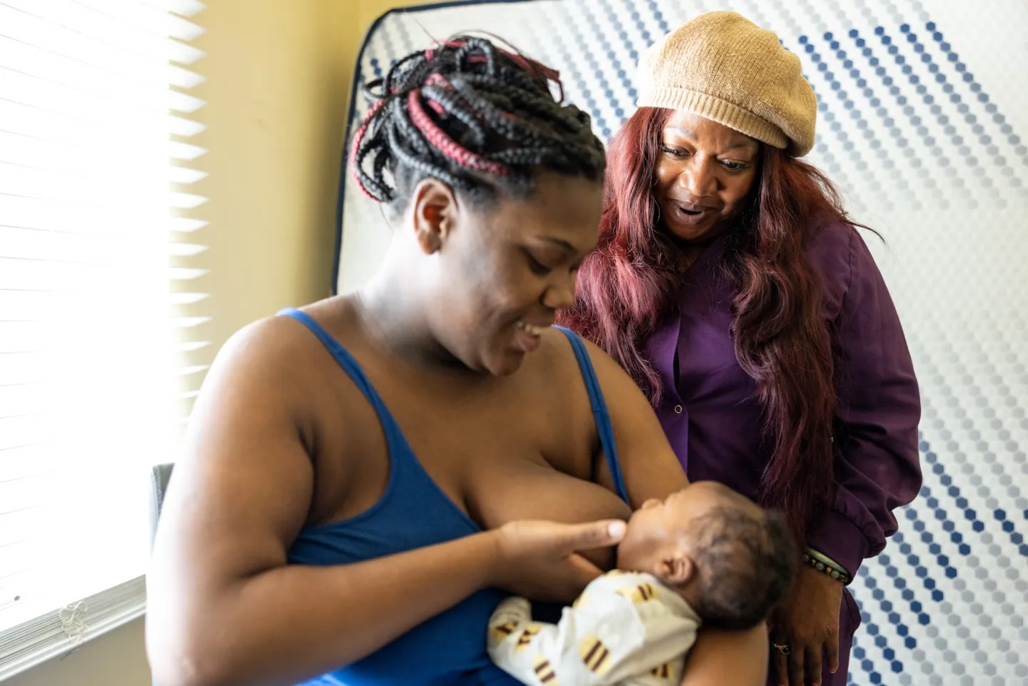 nursing mother and doula with newborn