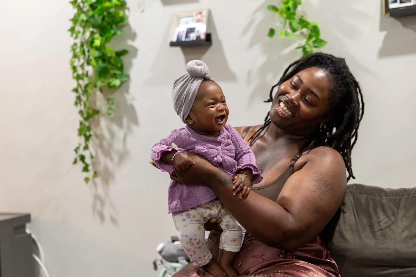 smiling and laughing newborn with her mother