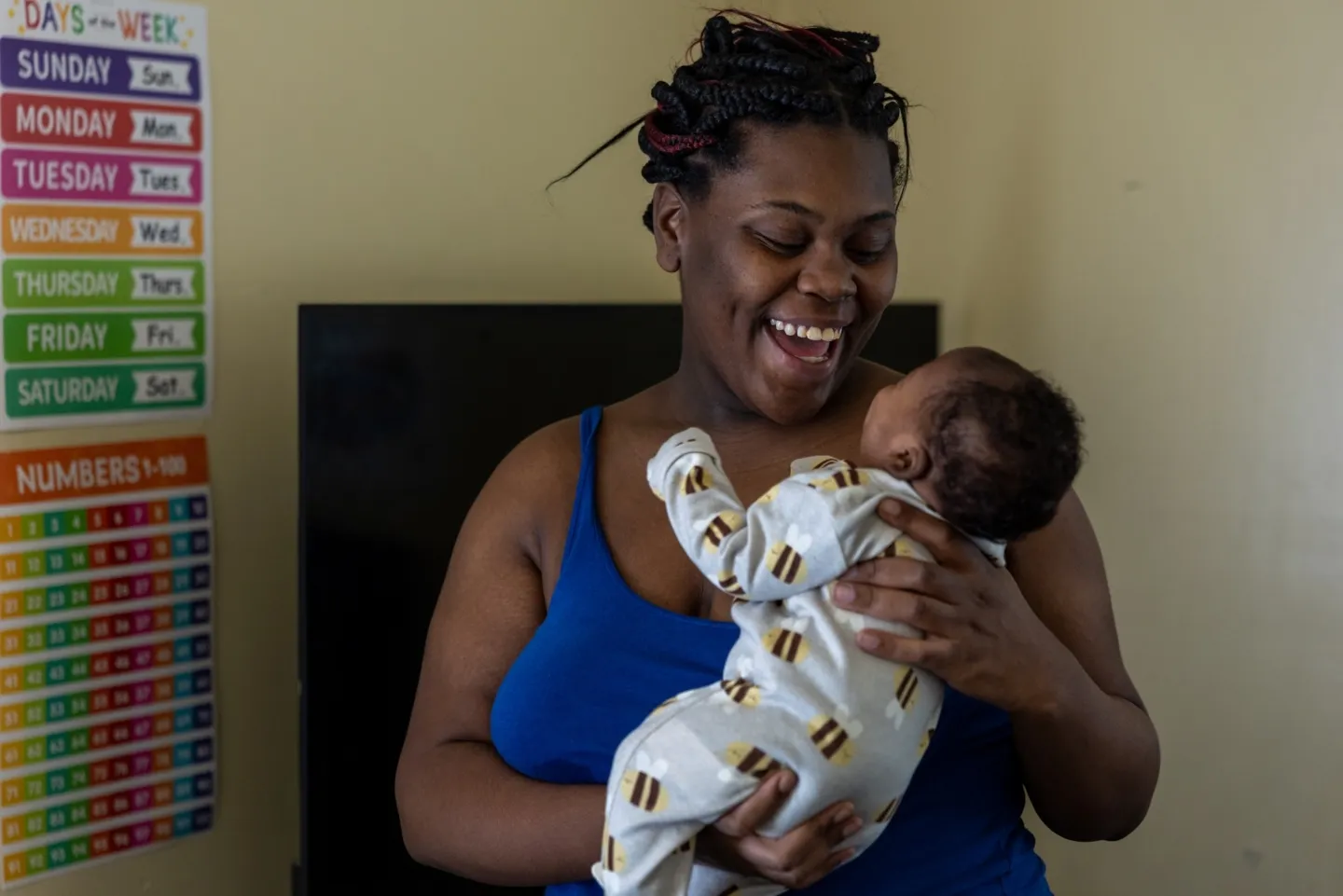 mother holding and smiling to newborn