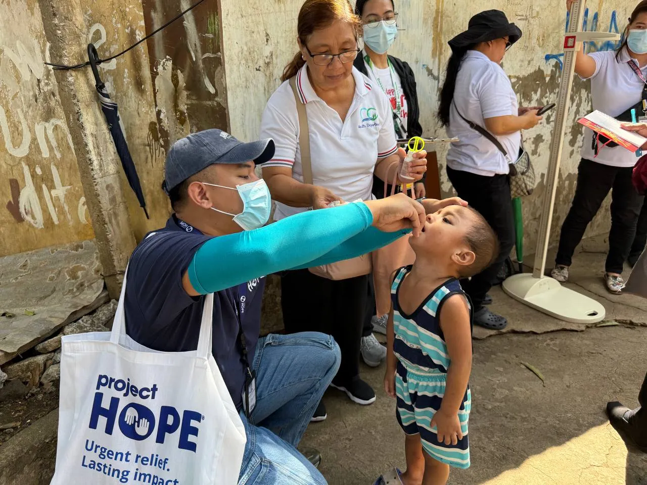 young boy receives medicine from medical staff in the Philippines